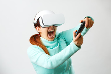 Woman with virtual reality headset is playing game.