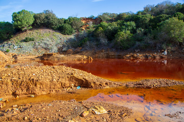 Pollution in the red lake 'Le Conche' on Elba island. Italy