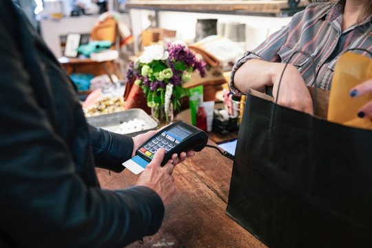 Man using credit card reader in shop