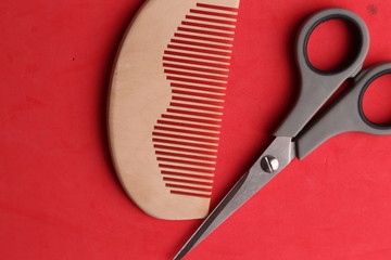 wooden comb and scissors in color background