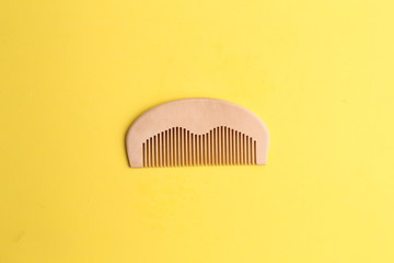 wooden comb in color background