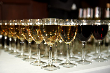Sparkling glassware with wine and champagne on dinner table in restaurant, copy space. Crystal glasses ready for celebration. Wineglasses at luxury wedding reception