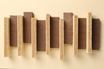 Flat lay with wafers on beige background, top view