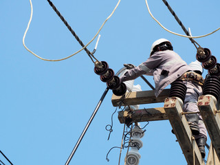 electrician man working at height and dangerous ,high voltage power line maintenance