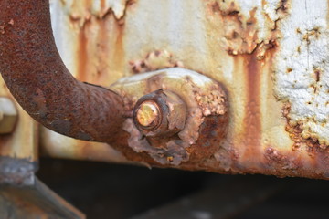 rusty bolt on yellow equipment