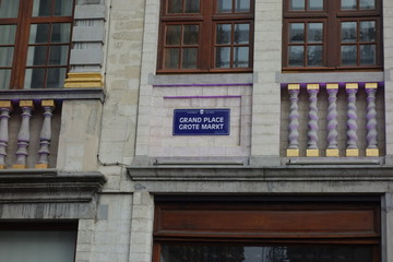 Fototapeta premium Grand Place or Grote Markt square name sign, the central square of Brussels, Belgium, surrounded by guildhalls and the city's Town Hall and the King's House or Breadhouse