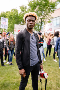 Portrait of student holding megaphone at climate change rally