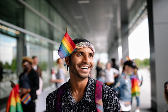 Portrait Of Student On Gay Pride Rally With Rainbow Flag In Bandanna