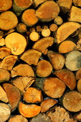 Wooden background. Firewood for the winter, stacks of firewood, pile of firewood