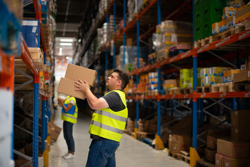 Workers in warehouse review the goods	