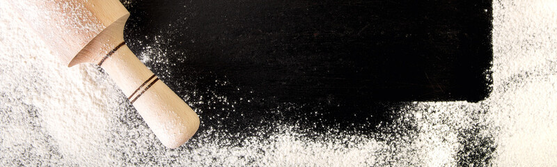 Banner with utensils, flour and egg on black background.