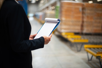 Women hands holding paper in warehouse