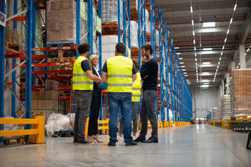 Warehouse staff meeting, workers with mnagers