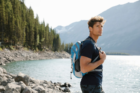 Portrait Confident Male Hiker At Sunny Lakeside