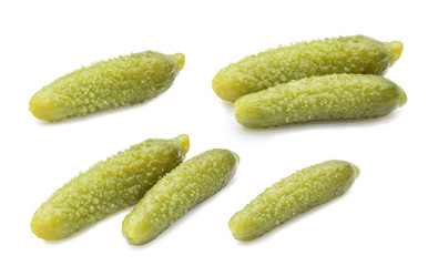 three marinated pickled cucumbers isolated on white
