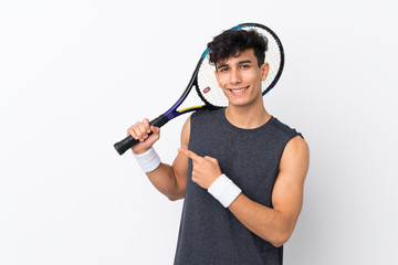 Young Argentinian man over isolated white background playing tennis and pointing to the lateral