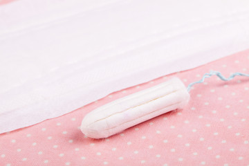 Tampon and sanitary pad or napkin on pink 