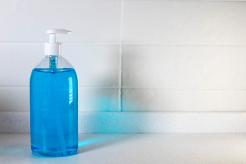Fragment of the interior of the kitchen. Liquid blue soap in a transparent plastic.