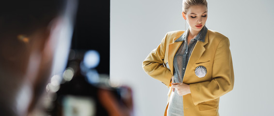 panoramic shot of stylish model posing for photographer