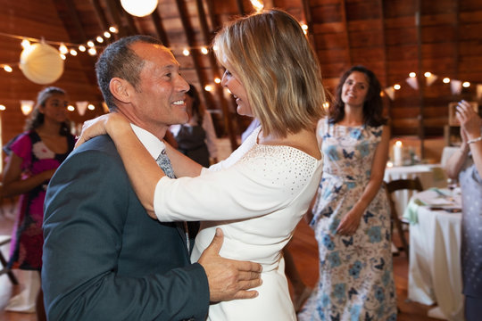 Happy Mature Bride And Groom Dancing At Wedding Ceremony