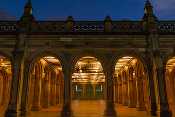 Arches leading into the Bethesda Arcade in New York City’s Central park at night.