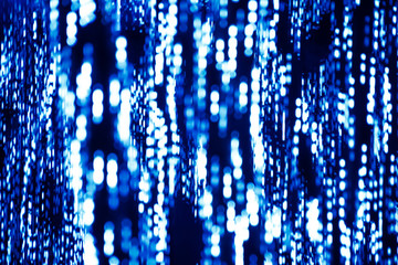 Naklejka na ściany i meble Abstract background of blue lights with the bokeh effect.