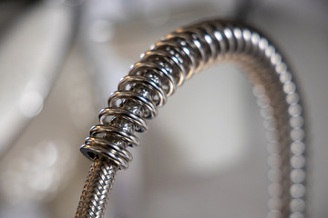 kitchen faucet, detail of metal coil spring. Domestic kitchen.