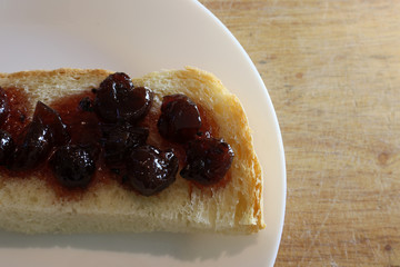 Slice of Bread with Cherry Jam. Homemade jam.
