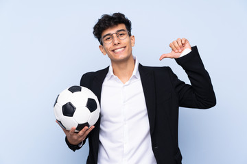 Argentinian Soccer coach over isolated blue background proud and self-satisfied