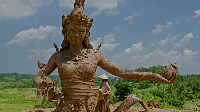 Woman near Statue of Goddess of fertility at Jatiluwih rice terrace, Bali