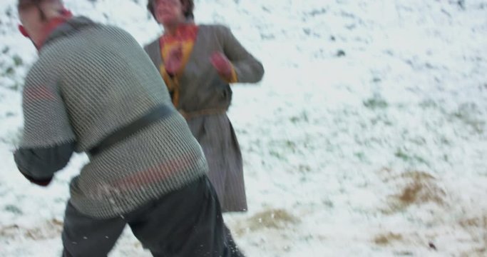 View of strong dogfight between armed cossacks in cold snowy middle ages