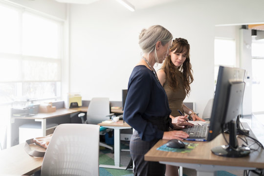 Two female colleagues at standing desk