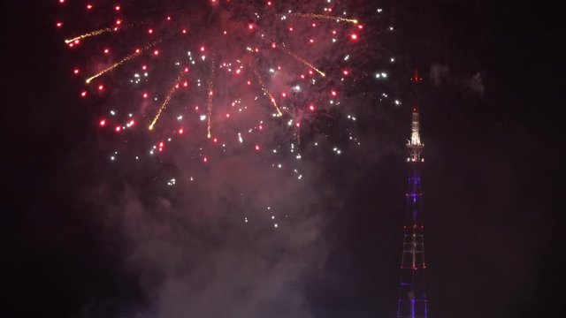 Beautiful colorful fireworks show and tv tower in the night sky, 4k