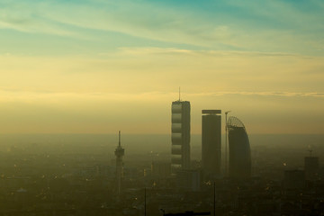 Milan landscape with smog, aerial view of the city with polluted air.