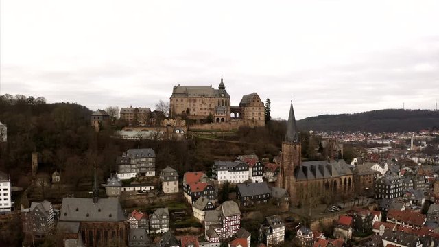 Circeling over the cityscape of Marburg, Hesse on a cloudy evening in winter.
