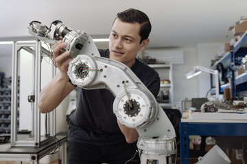 Engineer building a robotic arm