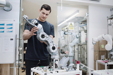 Engineer building a robotic arm