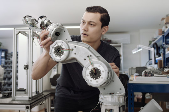 Engineer building a robotic arm