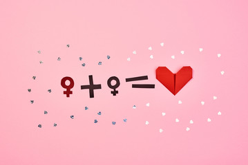 Sexual orientation concept. Symbols and signs of free love. Pink background. Top view.