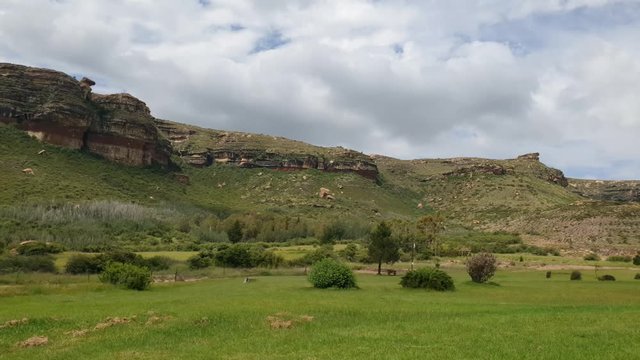 Scenic Camelroc Moluti mountain cloud time lapse in the late afternoon over the sandstone cliffs near the farm with Emu birds walking around