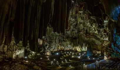 Panoramic picture of Melidoni Cave on crete island with altar and stone cross without people