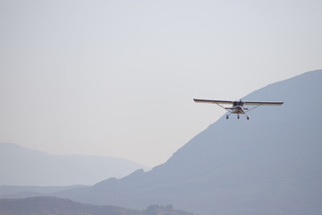 Fototapeta na wymiar airplane in the sky, over mountains