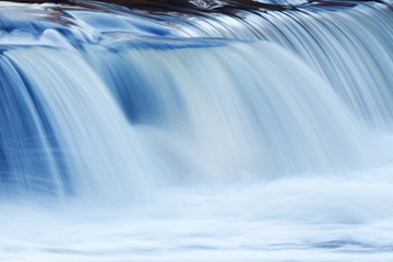 Landscape captured with blurred motion of a cascade on the Rabbit River, Michigan, USA