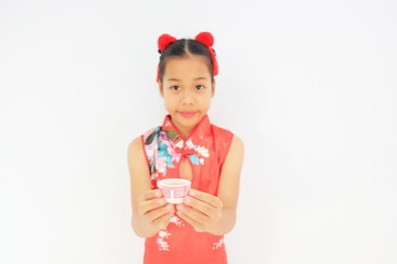 Happy Chinese new year concept. Asian girl in a Chinese costume showing a pay respect ,Asian girl put on Chinese traditional dress.on isolate white background.