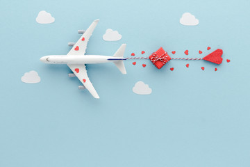 White top view Airplane .Airplane hearts gift blue cloud sky background with copy space for your text. Flat lay.