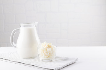 Homemade fermented beverage kefir with kefir grains in bowl on a white background, concept of...