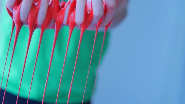 Art Class bright red paint flowing through little fingers