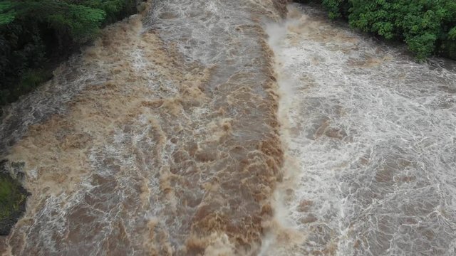 aerial boom down to closeup of flash flood in hilo hawaii