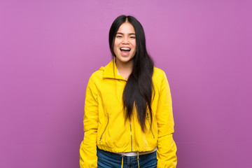 Fototapeta premium Young teenager Asian girl over isolated purple background with surprise facial expression