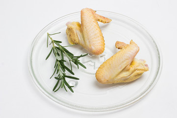 Clean food concept. Parts of organic chicken (wing) with yellowish skin grown by free range method outdoors.